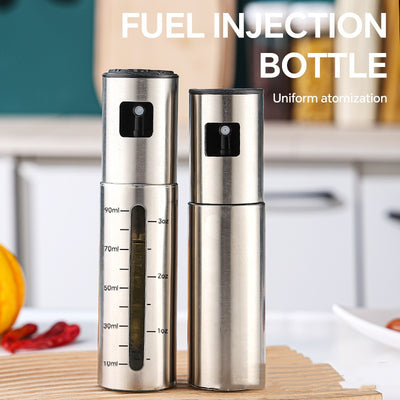 Two stainless steel fuel injection bottles with measurement markings on a kitchen counter.